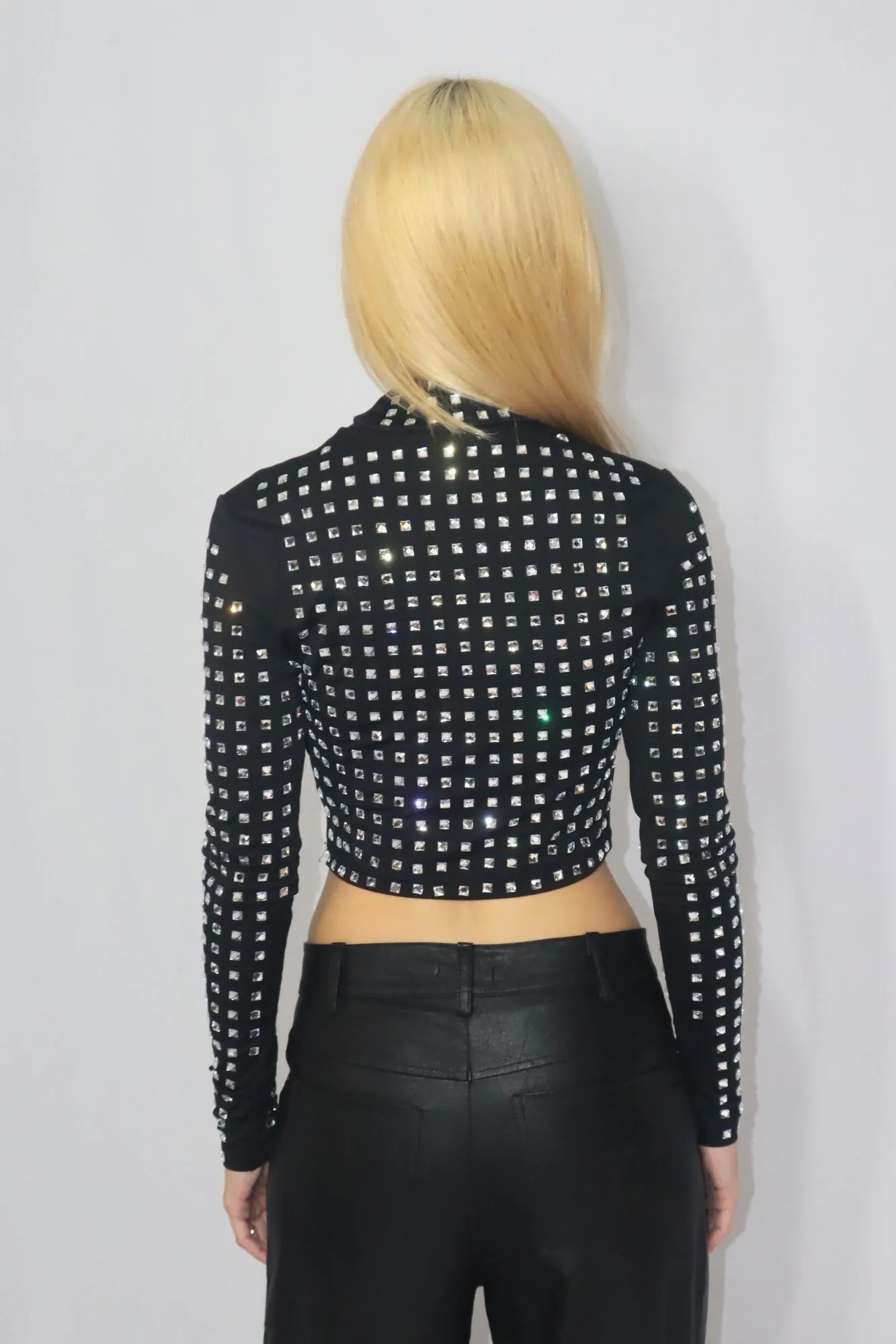 Blusa cropped de mangas compridas e gola alta, com Strass aplicados.